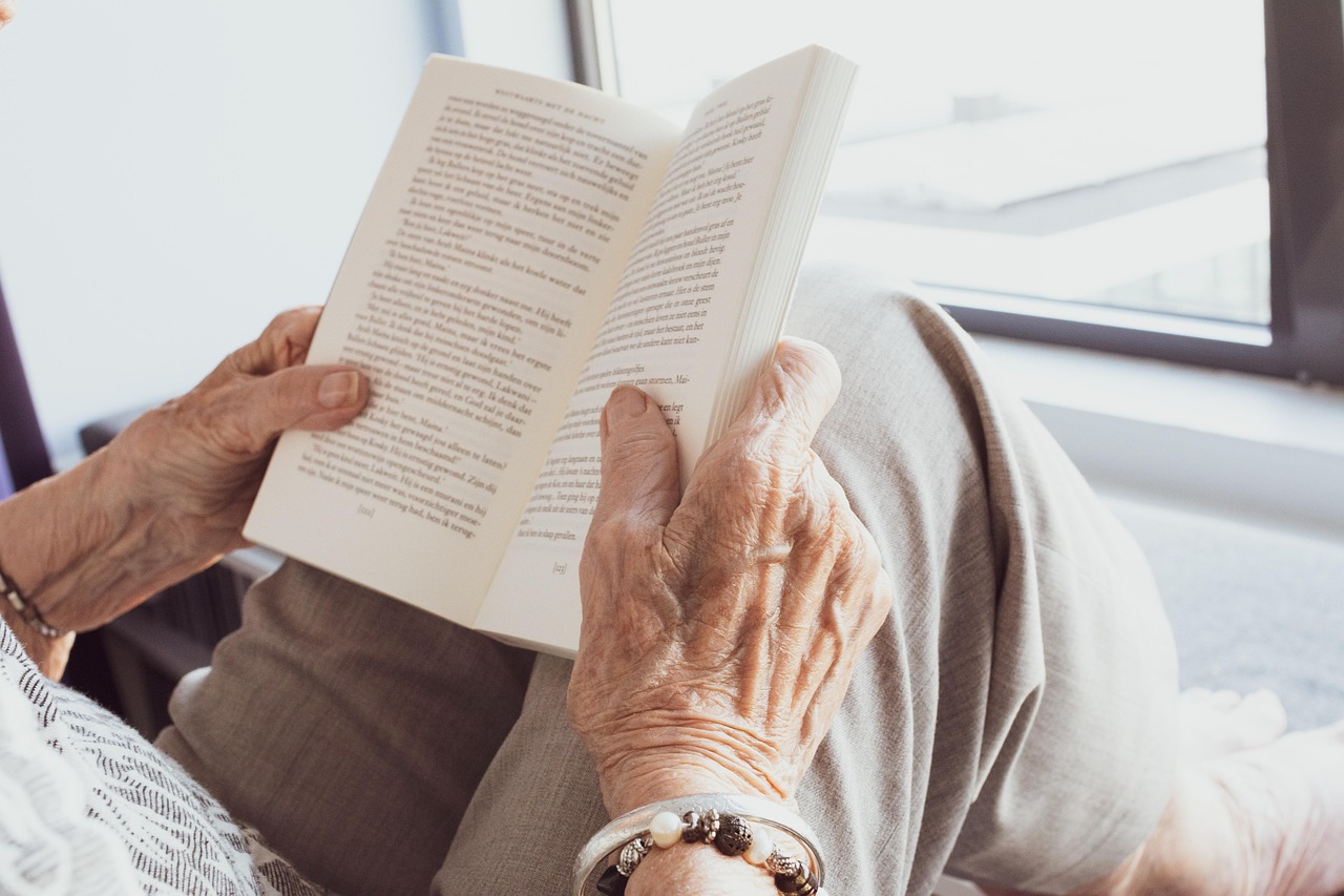 Resident relaxing reading a book by a window